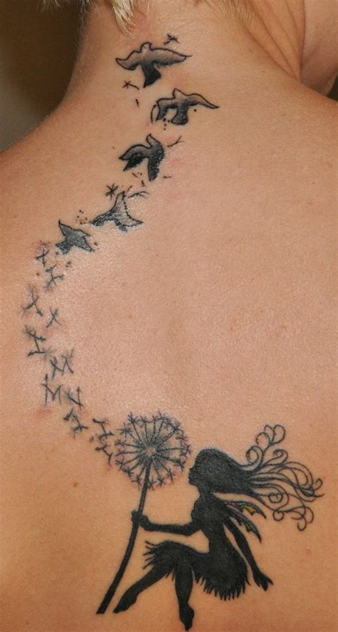 A Woman With A Dandelion Tattoo On Her Back Is Looking At Birds Flying