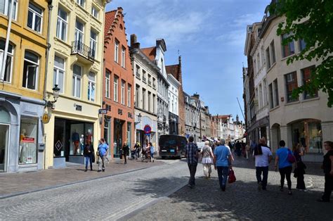 Bruges, Belgium - May 11, 2015: Tourists Visit Steenstraat Shopping Street in Bruges, Belgium ...