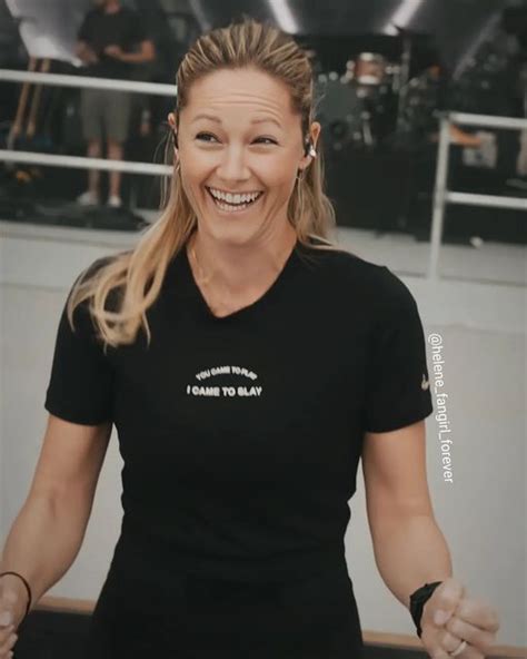 A Smiling Woman In A Black Shirt Is Holding Her Hands Out