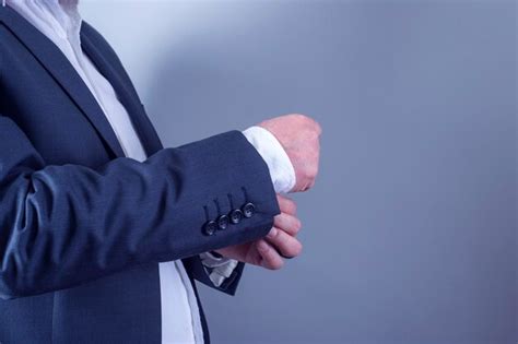 Premium Photo | Businessman fixing cufflinks to his suit