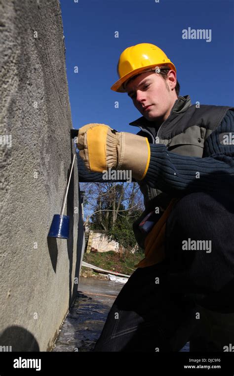 Tradesman using a tool Stock Photo - Alamy