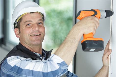 Young Man Drilling Hole In Wall Stock Photo Image Of Hardhat