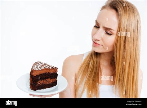 Pensive Beautiful Young Woman Looking At Piece Of Chocolate Cake Over