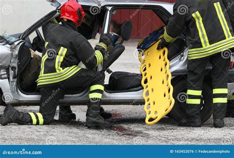 Team Of Firefighters On The Road After The Crash Stock Photo Image Of