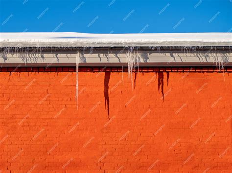 Premium Photo Large Winter Icicles Hanging From The House Roof