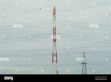 A High Voltage Power Line Towers Against A Clear Blue Sky Carrying