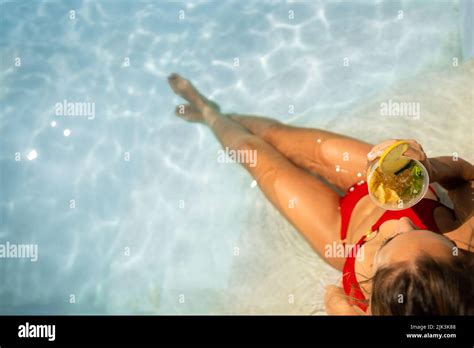 Woman In Red Bikini Having A Mojito Cocktail Inside The Swimming Pool In Summer Aerial View