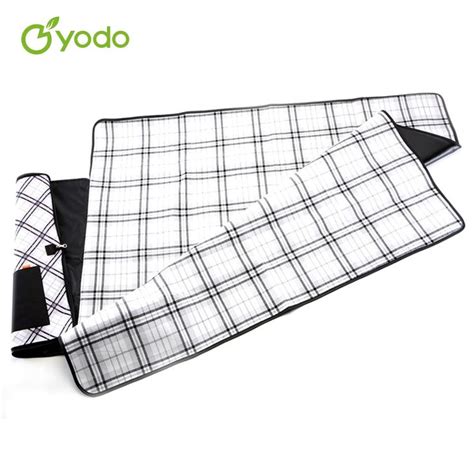 A Black And White Checkered Table Cloth Next To An Oven Mitt On A White