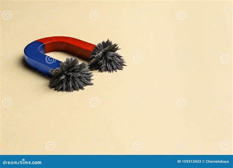 Horseshoe Magnet With Iron Filings On Background Space For Text Stock