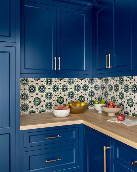 Bright Blue Cabinets With Green And Orange Mosaic Backsplash Tiles