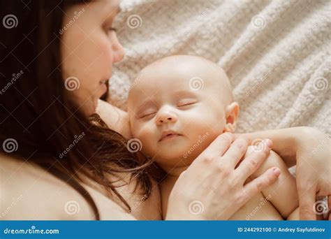 A Beautiful Naked Baby Sleeps In His Mother X S Arms The Happiness Of Motherhood Stock Photo