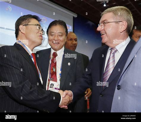 International Olympic Committee President Thomas Bach R Shakes Hands