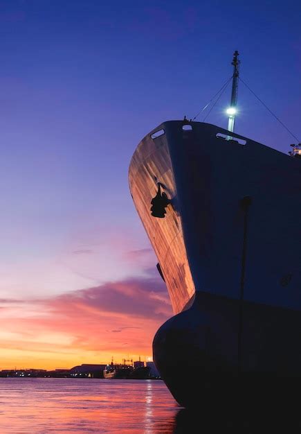 Premium Photo Silhouette Oil Tanker Ship Moored At Harbor Against