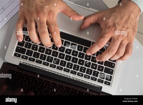 Fingers typing on a keyboard Stock Photo - Alamy