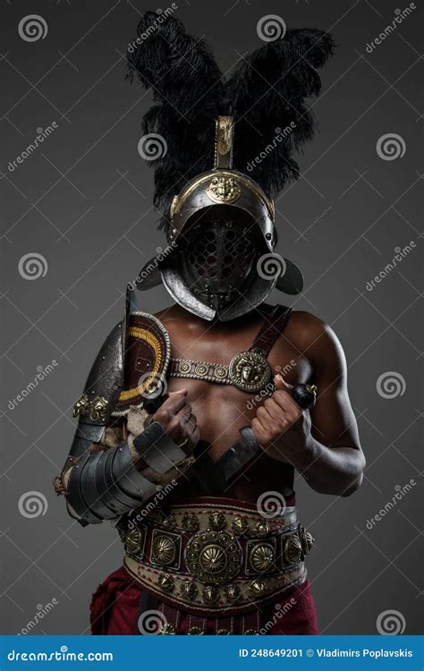 Aggressive Roman Gladiator Of African Ethnic Against Grey Background