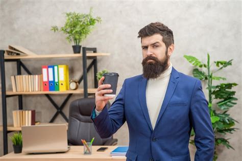 Premium Photo Serious Mature Entrepreneur In Jacket Having Coffee