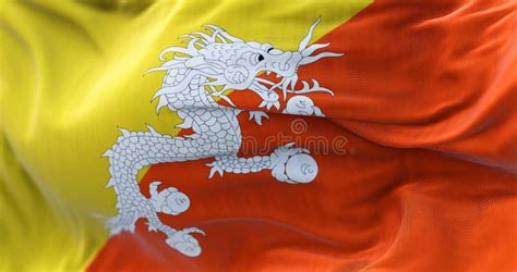 Close Up View Of The Bhutan National Flag Waving In The Wind Stock