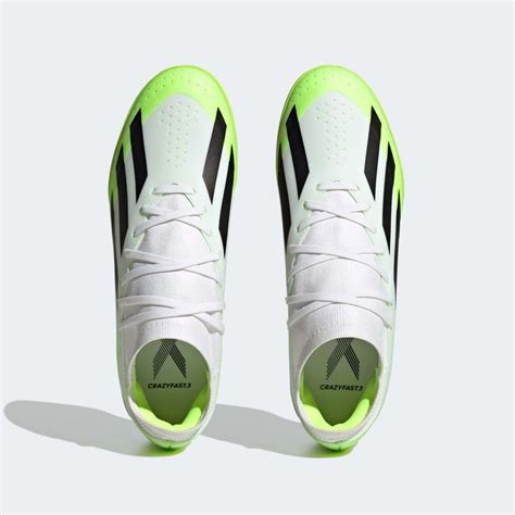 A Pair Of White And Black Shoes With Neon Green Accents On The Soles