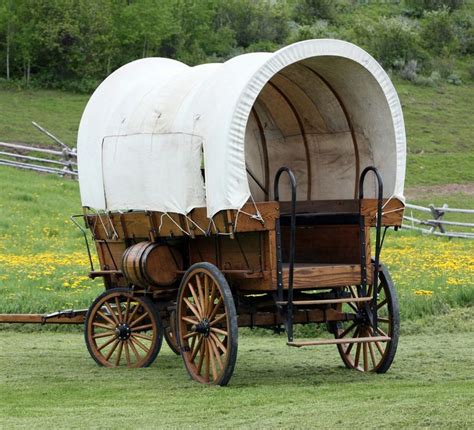 An Old Fashioned Covered Wagon In A Field