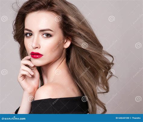 Portrait Of Beautiful Blonde Woman With Curly Hairstyle And Bright