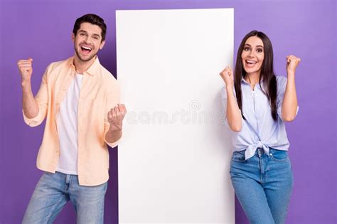 Portrait Of Two Delighted Partners Raise Fists Celebrate Accomplishment