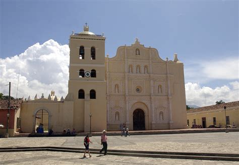 A Honduran Couple Crosses The Plaza In Front Of The Inmaculada