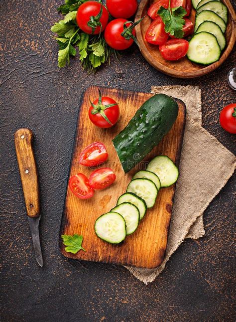 Sliced Tomato And Cucumber On Cutting Board Stock Photo Image Of