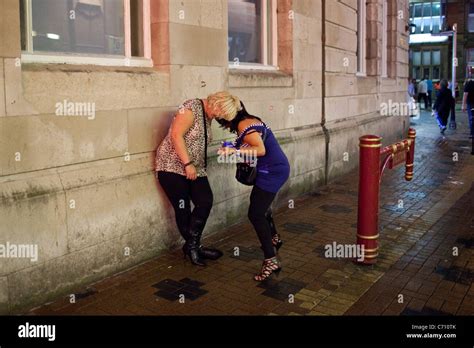 Two Women Urinate Thorough Their Clothes Outside One Of The Clubs On