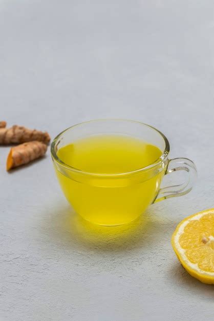 Premium Photo Cup Of Healing Turmeric Tea With Lemon And Ginger On