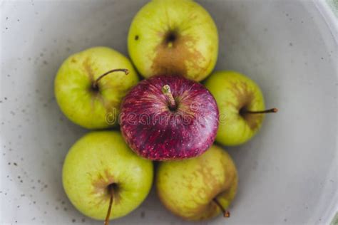 Group Of Green Apples With One Red Apple In The Middle Healthy Food Or