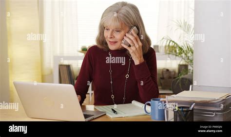 Mature Woman Talking Smartphone Laptop Computer Stock Photo Alamy