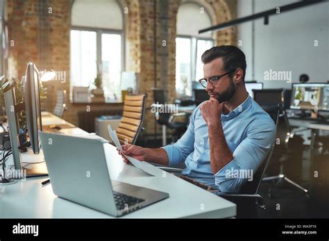 Analyzing Data Side View Of Concentrated Bearded Man In Eyeglasses And