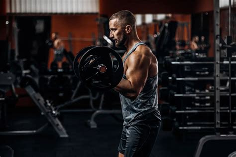 Download Attractive Man Weight Lifting Wallpaper | Wallpapers.com