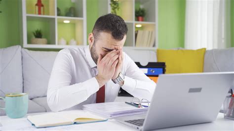 Unhappy and troubled man crying at home, feeling depressed. Man at home