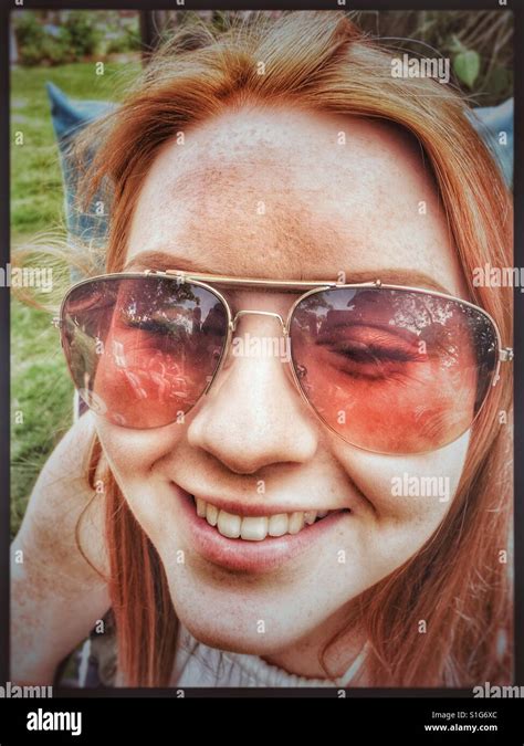 Woman With Red Hair Wearing Sunglasses Stock Photo Alamy