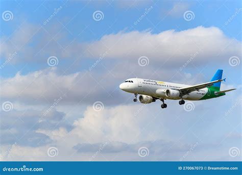 Vueling Aircraft Flying In The Sky With Its Landing Gear Extended