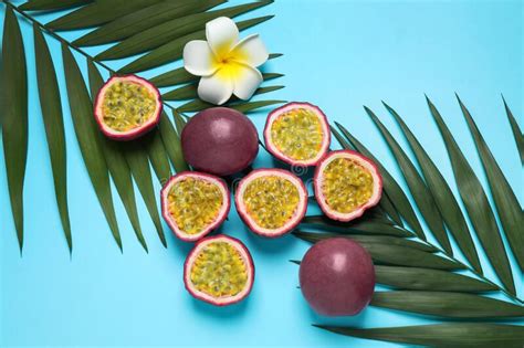 Passion Fruits Maracuyas Flower And Palm Leaves On Light Blue