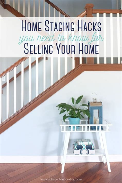 A White Table Sitting Under A Stair Case Next To A Wooden Banister With