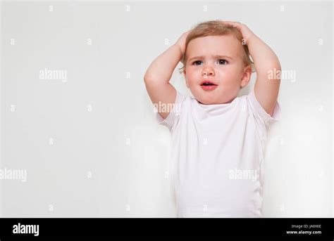 Surprised Baby Girl And Put Her Hand On The Head Stock Photo Alamy