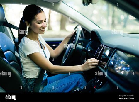 A Woman Amateur Driver Is Playing The Radio In The Car Before Start Driving Traveling With