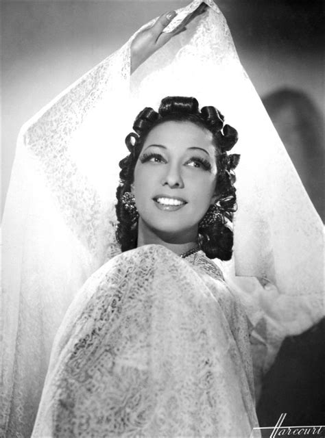 An Old Black And White Photo Of A Woman Wearing A Veil