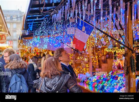 Tourist Looking Up At A Display Of Christmas Themed Lights For Sale In