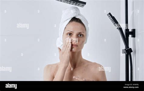A Caucasian Woman Applying Facial Cream After Taking A Hot Shower Stock Photo Alamy