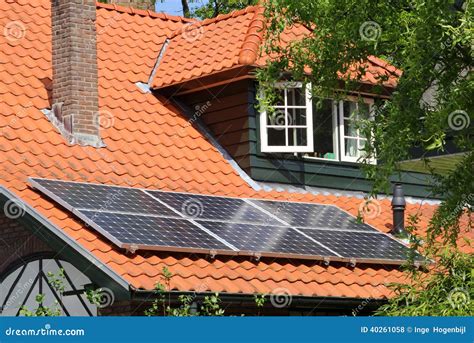 Modern Solar Panels As An Alternative Energy Source On Scenic Red Tiled