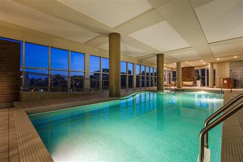 Indoor pool with city view at Warwick Le Crystal - Montreal