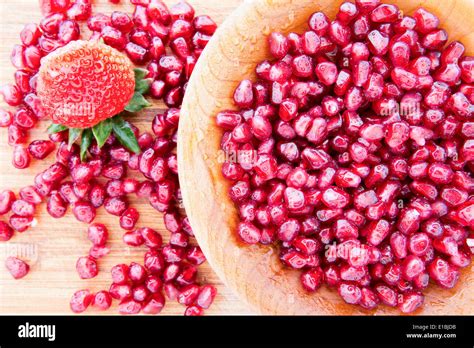 Wooden Bowl Of Fresh Pomegranate Seeds Rich In Vitamins And