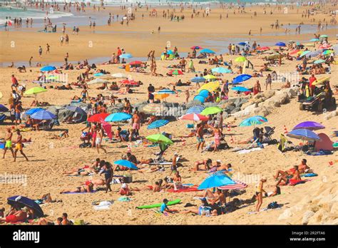 Crowded Beach Full Of People Resting On Beach During Their Vacation In