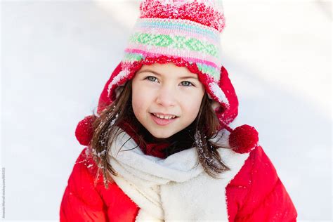 Beautiful Young Girl Wearing Red Winter Gear Looking At Camera By