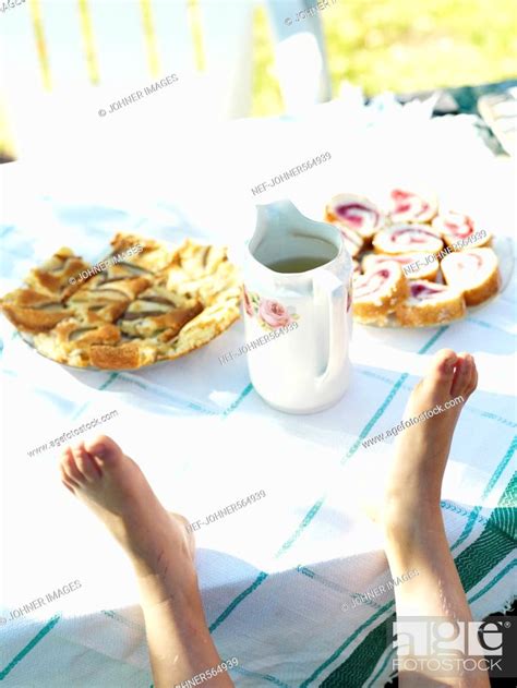 A child's feet on a table in the garden, Sweden, Stock Photo, Picture ...