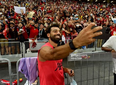 Mohamed Salah Of Liverpool Taking A Selfie With Fans At The End Of A